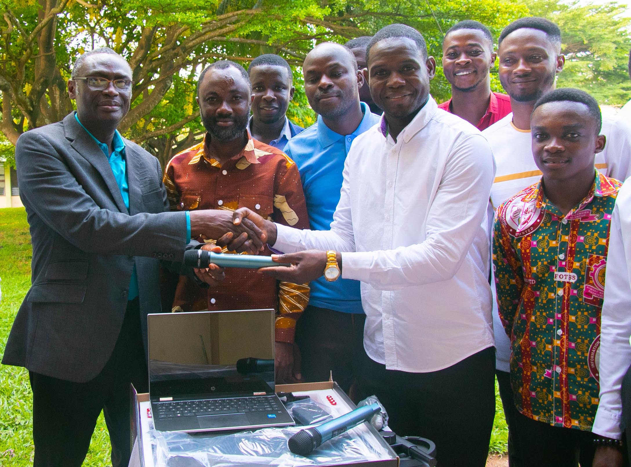 The Registrar, Mr. Augustus Kwaw Brew (First left) receiving the gadgets from the SRC President, Mr. Prince Yaw Malba