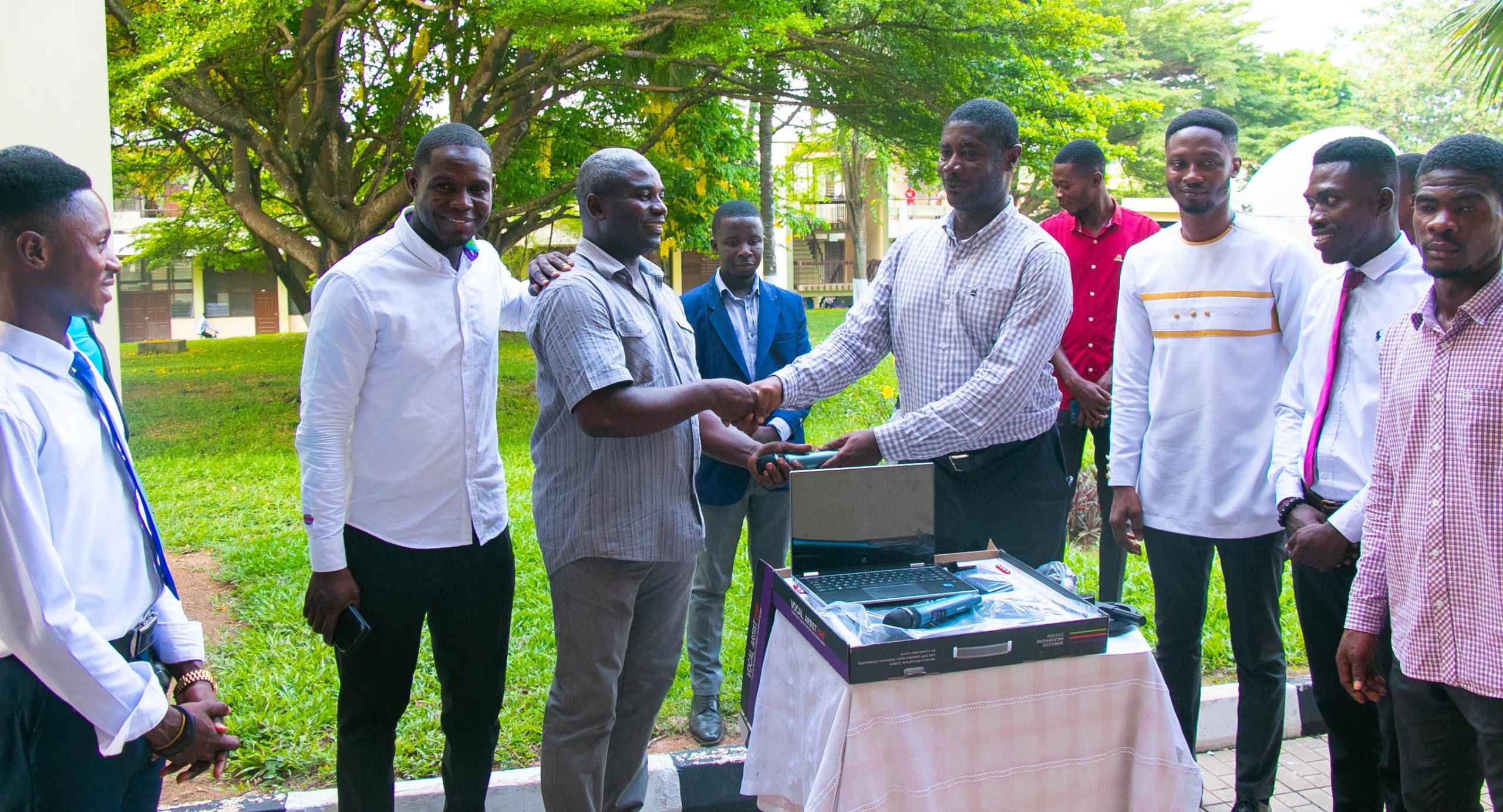 The Director of Public Affairs(DPA) Mr. M. K. Twum-Ampomah ( fourth right) given out the gagdets to the Manager of MYND FM, Mr. Richmond Butler